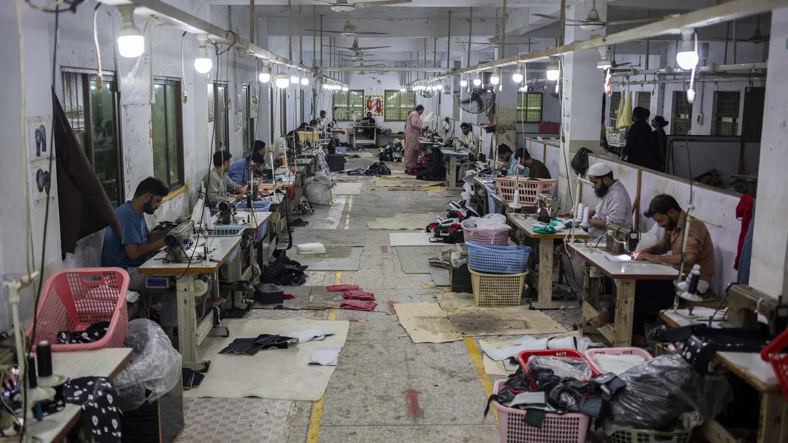 Factory workers inspecting gloves